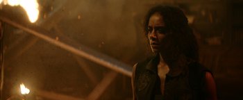 Movie still from “Resident Evil: Welcome to Raccoon City” (2021), directed by Johannes Roberts – A woman standing in front of a fire hydrant; Close Up shot, Over the shoulder angle