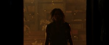 Movie still from “Resident Evil: Welcome to Raccoon City” (2021), directed by Johannes Roberts – A man standing in the rain with a gun in his hand; Medium shot, Low angle