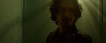 Movie still from “Resident Evil: Welcome to Raccoon City” (2021), directed by Johannes Roberts – A person in a dark room; Close Up shot, Low angle