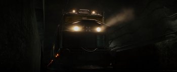 Movie still from “Resident Evil: Welcome to Raccoon City” (2021), directed by Johannes Roberts – A train engine with its lights on at night; Extreme Wide shot, Low angle