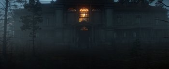 Movie still from “Resident Evil: Welcome to Raccoon City” (2021), directed by Johannes Roberts – A building that has a window in the middle of the night; Extreme Wide shot, Low angle