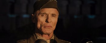 Movie still from “Resistance” (2020), directed by Jonathan Jakubowicz – An older man in a military uniform is looking at the camera; Close Up shot, Low angle