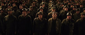 Movie still from “Resistance” (2020), directed by Jonathan Jakubowicz – A large group of men in military uniforms; Wide shot, High angle