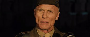 Movie still from “Resistance” (2020), directed by Jonathan Jakubowicz – An older man wearing a military uniform and a hat; Close Up shot, Low angle