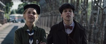 Movie still from “Resistance” (2020), directed by Jonathan Jakubowicz – A man and a woman standing next to each other; Close Up shot, Low angle