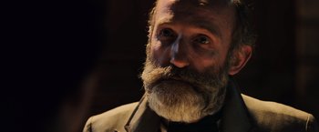 Movie still from “Resistance” (2020), directed by Jonathan Jakubowicz – An old man with a beard and a mustache; Close Up shot, Over the shoulder angle