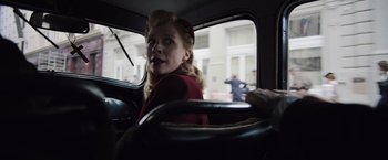Movie still from “Resistance” (2020), directed by Jonathan Jakubowicz – A woman sitting in the driver's seat of a car; Close Up shot, Low angle