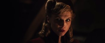 Movie still from “Resistance” (2020), directed by Jonathan Jakubowicz – A person wearing a red shirt; Close Up shot, Low angle