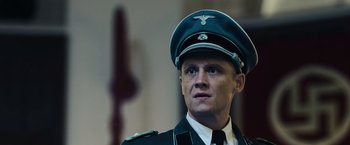 Movie still from “Resistance” (2020), directed by Jonathan Jakubowicz – A person wearing a uniform; Close Up shot, Low angle