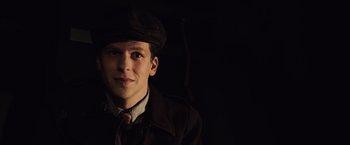 Movie still from “Resistance” (2020), directed by Jonathan Jakubowicz – A young man wearing a hat and a jacket; Close Up shot, High angle