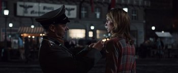 Movie still from “Resistance” (2020), directed by Jonathan Jakubowicz – A man and a woman in nazi garb putting makeup on; Medium shot, Over the shoulder angle