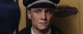 Movie still from “Resistance” (2020), directed by Jonathan Jakubowicz – A person wearing a hat; Close Up shot, Low angle