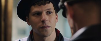 Movie still from “Resistance” (2020), directed by Jonathan Jakubowicz – A person wearing a hat; Close Up shot, Over the shoulder angle