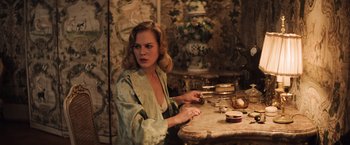 Movie still from “Resistance” (2020), directed by Jonathan Jakubowicz – A woman sitting at a table in front of a mirror; Medium shot, Over the shoulder angle