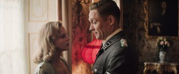 Movie still from “Resistance” (2020), directed by Jonathan Jakubowicz – A man and a woman standing next to each other; Medium shot, Over the shoulder angle