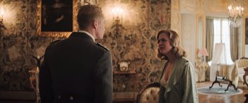 Movie still from “Resistance” (2020), directed by Jonathan Jakubowicz – A man and a woman are standing in a room; Medium shot, Over the shoulder angle