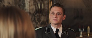 Movie still from “Resistance” (2020), directed by Jonathan Jakubowicz – A man in a military uniform looking at a mirror; Close Up shot, Over the shoulder angle