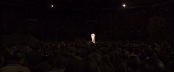 Movie still from “Resistance” (2020), directed by Jonathan Jakubowicz – A crowd of people are sitting in a dark room; Extreme Wide shot, High angle
