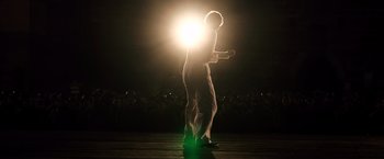 Movie still from “Resistance” (2020), directed by Jonathan Jakubowicz – A man standing in front of a crowd at night; Medium shot, Low angle