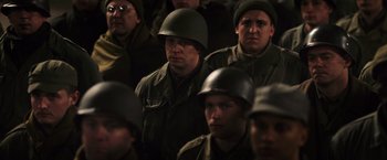 Movie still from “Resistance” (2020), directed by Jonathan Jakubowicz – A group of men in military uniforms and helmets; Medium shot, High angle