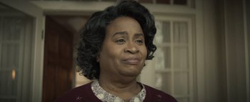 Movie still from “Respect” (2021), directed by Liesl Tommy – An older black woman wearing a red sweater; Close Up shot, Over the shoulder angle