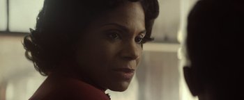 Movie still from “Respect” (2021), directed by Liesl Tommy – A woman's face in a red jacket; Close Up shot, Over the shoulder angle