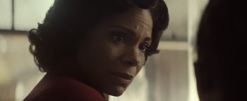 Movie still from “Respect” (2021), directed by Liesl Tommy – A woman's face in a red shirt; Close Up shot, Over the shoulder angle