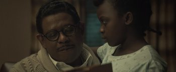 Movie still from “Respect” (2021), directed by Liesl Tommy – A man and a young girl looking at a book together; Close Up shot, Over the shoulder angle