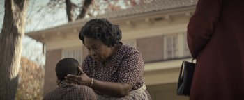 Movie still from “Respect” (2021), directed by Liesl Tommy – An older black woman holding a young black man's head; Close Up shot, Over the shoulder angle