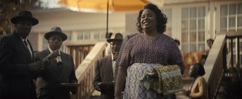 Movie still from “Respect” (2021), directed by Liesl Tommy – An older man and woman standing next to each other; Medium shot, Over the shoulder angle