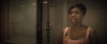 Movie still from “Respect” (2021), directed by Liesl Tommy – A woman standing in front of a microphone in front of a mirror; Close Up shot, Over the shoulder angle