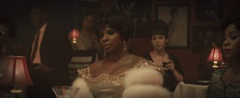 Movie still from “Respect” (2021), directed by Liesl Tommy – A woman in a white dress and a man in a black suit; Close Up shot, Over the shoulder angle