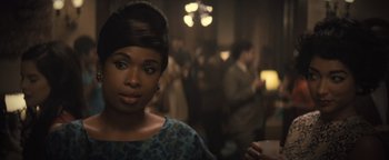 Movie still from “Respect” (2021), directed by Liesl Tommy – A woman in a blue dress is in a crowd; Close Up shot, Over the shoulder angle