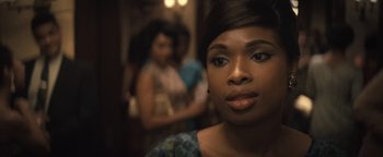 Movie still from “Respect” (2021), directed by Liesl Tommy – A woman's face in front of other women; Close Up shot, Over the shoulder angle