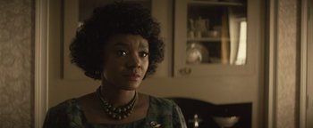 Movie still from “Respect” (2021), directed by Liesl Tommy – A woman in a green dress and a necklace; Close Up shot, Over the shoulder angle