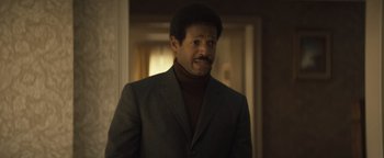 Movie still from “Respect” (2021), directed by Liesl Tommy – A man in a suit standing in a hallway; Close Up shot, Low angle