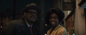 Movie still from “Respect” (2021), directed by Liesl Tommy – A man and a woman posing for a picture; Medium shot, Low angle