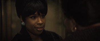 Movie still from “Respect” (2021), directed by Liesl Tommy – A person sitting down with her eyes wide open; Close Up shot, Over the shoulder angle