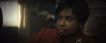 Movie still from “Respect” (2021), directed by Liesl Tommy – A person wearing a red jacket; Close Up shot, Over the shoulder angle