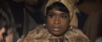 Movie still from “Respect” (2021), directed by Liesl Tommy – A person wearing a head scarf; Close Up shot, Over the shoulder angle