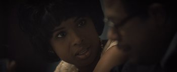 Movie still from “Respect” (2021), directed by Liesl Tommy – A person with a hand on his chin; Close Up shot, Over the shoulder angle