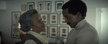 Movie still from “Respect” (2021), directed by Liesl Tommy – A man and a woman standing next to each other in a room; Close Up shot, Over the shoulder angle