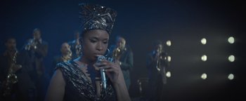 Movie still from “Respect” (2021), directed by Liesl Tommy – A woman with a microphone in front of a group of people; Close Up shot, Over the shoulder angle