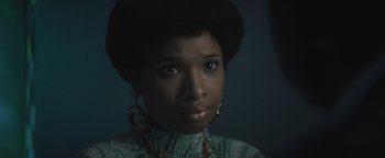 Movie still from “Respect” (2021), directed by Liesl Tommy – A person wearing a green shirt; Close Up shot, Over the shoulder angle