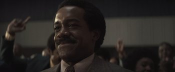 Movie still from “Respect” (2021), directed by Liesl Tommy – A person wearing a suit and tie; Close Up shot, Low angle