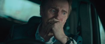 Movie still from “Retribution” (2023), directed by Nimród Antal – A person sitting in a car with his hand on his chin; Close Up shot, Over the shoulder angle