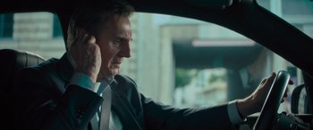 Movie still from “Retribution” (2023), directed by Nimród Antal – A man in a suit and tie driving a car; Close Up shot, Over the shoulder angle