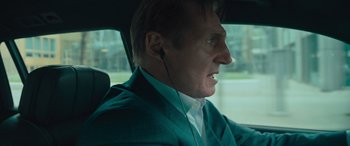 Movie still from “Retribution” (2023), directed by Nimród Antal – A man in a car wearing a green jacket and white shirt; Close Up shot, Over the shoulder angle