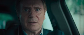 Movie still from “Retribution” (2023), directed by Nimród Antal – An older man in a car looking at the camera; Close Up shot, Over the shoulder angle