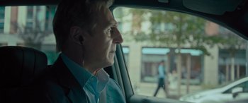 Movie still from “Retribution” (2023), directed by Nimród Antal – A man wearing headphones looking out of a car window; Close Up shot, Over the shoulder angle